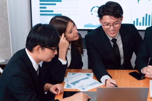 Business team of financial data analysis meeting with business intelligence, report paper and dashboard on laptop for marketing strategy. Business people working together to promote harmony in office.