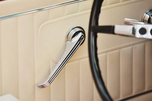 Beige leather vintage car door with a metal handle