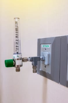 Oxygen flow meter with adapter for pipe on the background.