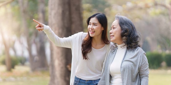 Portrait of an adult daughter with her elderly mother with hug and happy moment.