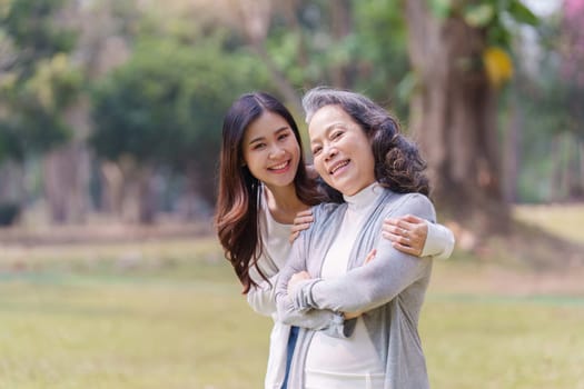Portrait of an adult daughter with her elderly mother with hug and happy moment.