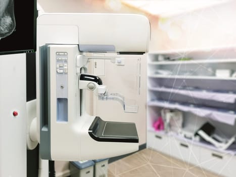 Mammography machine with monitor for breast screening device on mammogram room background.