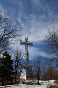 Jacques Cartier Cross at Mount Royal Montreal, Quebec, Canada, built in 1924 taken in late winter with snow on the ground and bare trees