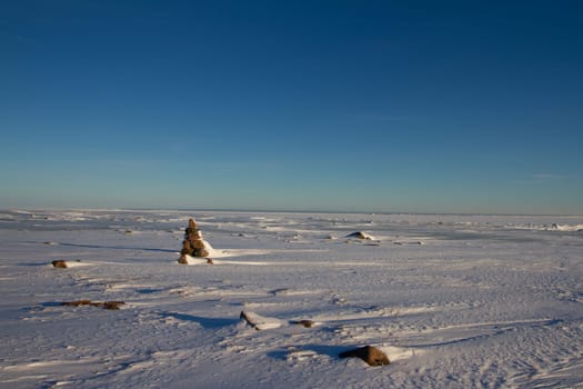 Frozen arctic landscape with snow on the ground near Arviat, Nunavut, Canada