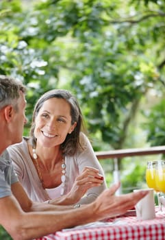 Their love grows deeper everyday. a mature couple bonding while having breakfast together outdoors