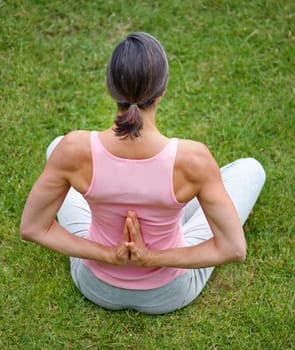 Enjoying a calm stretch. an attractive mature woman doing yoga outdoors