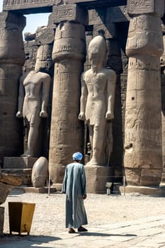 Luxor, Egypt - April 15 2008: The great statues of Ramses II with local population, Karnak, Luxor, Egypt