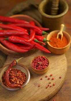 fresh red chili peppers on wooden board - chili background