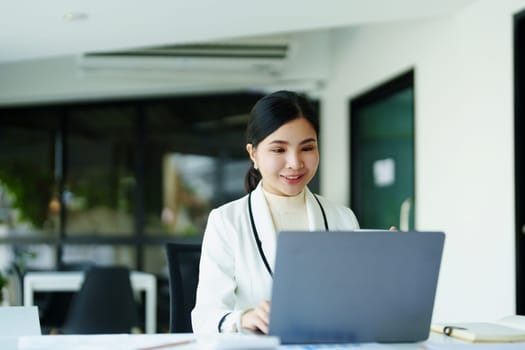 A portrait of a female employee using a computer video conferencing to discuss work through the Internet network.