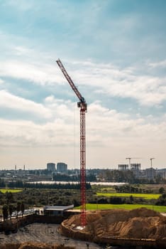 Construction crane working on large construction site