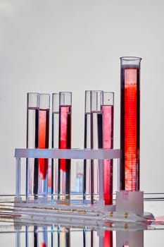 Set of lab test tubes with samples of blood. Vertical shot white background.