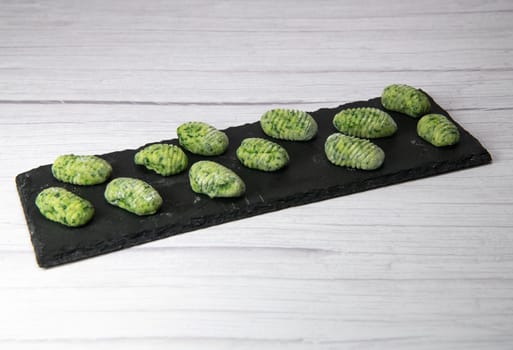 Pile of green spinach gnocchi, potato peru italian food, Homemade, High quality photo