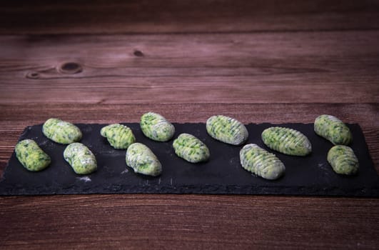 Pile of green spinach gnocchi, potato peru italian food, Homemade, High quality photo