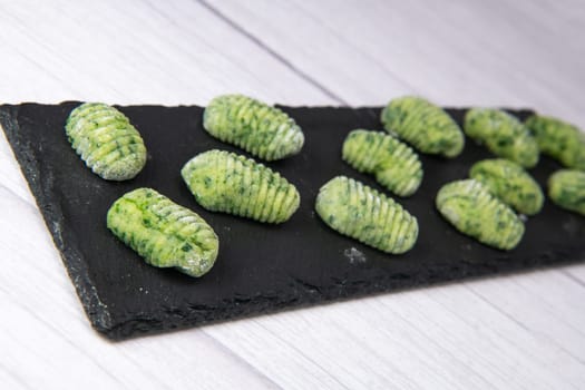 Pile of green spinach gnocchi, potato peru italian food, Homemade, High quality photo