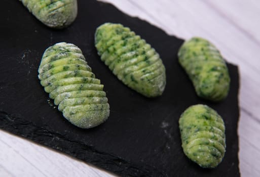 Pile of green spinach gnocchi, potato peru italian food, Homemade, High quality photo