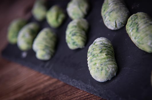 Pile of green spinach gnocchi, potato peru italian food, Homemade, High quality photo