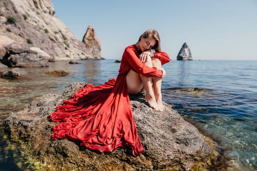 Woman travel sea. Happy tourist taking picture outdoors for memories. Woman traveler looks at the edge of the cliff on the sea bay of mountains, sharing travel adventure journey.