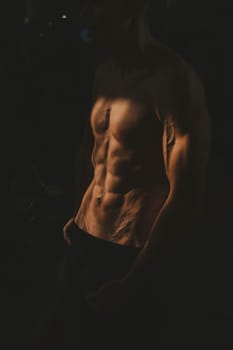 Shirtless man with sculpted body in the gym