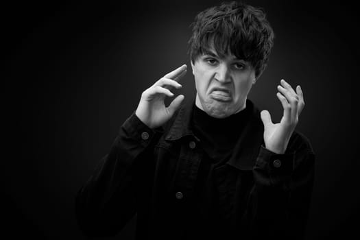 portrait of crazy young man with awesome hairdo grimacing . black and white