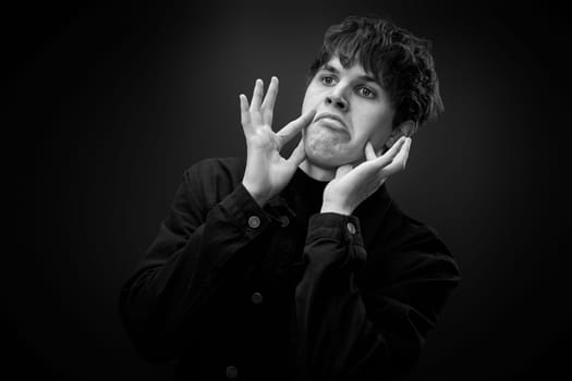 portrait of crazy young man with awesome hairdo grimacing . black and white