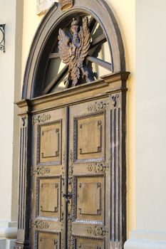 part of an old wooden door with a stained glass pattern.