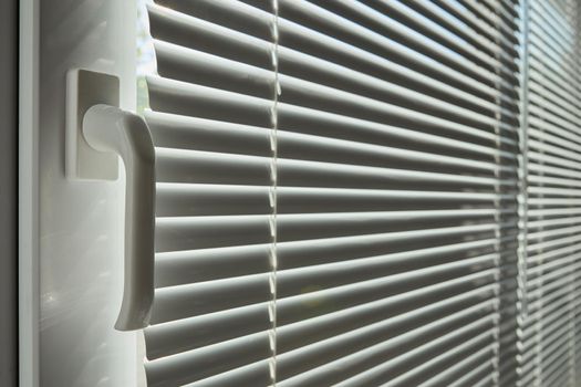 Abstract jalousie with window opening handle background interior image. Soft focus striped silhouette