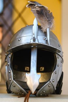 An ancient knight's helmet with a feather .Medieval concept.