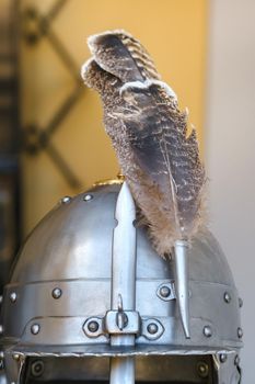 An ancient knight's helmet with a feather .Medieval concept.