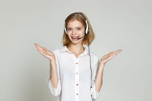 friendly smiling blonde woman with headset is consulting clients online. Call center, business people concept