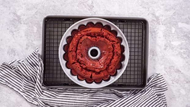 Flat lay. Step by step. Cooling freshly baked red velvet bundt cake on a kitchen drying rack.