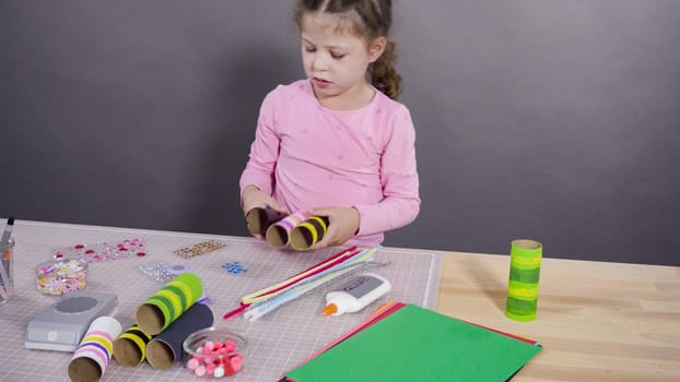 Kids papercraft. Making paper bugs out of the empty toilet paper rolls and construction paper.