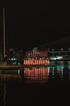 Vertical shot of the Sauna house in Tromso harbor at night. Norway