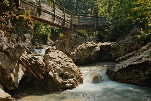 Wooden bridge over the Seisenbergklamm gorge in Weissbach bei Lofer, Austria with jagged rocks around