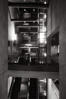 Escalator, concrete, and glass in a futuristic underground station in Heumarkt Cologne, Germany