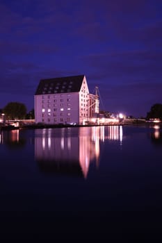 Old storehouse with white facade at night at the old harbour in Muenster in Westphalia, North Rhine-Westphalia Germany