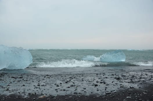 Black sand and crystal clear ice chunks at Diamond Beach in Fellsfjara, Jokulsarlon on Iceland