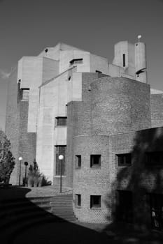 Vertical grayscale shot of a church tower with a spiral staircase