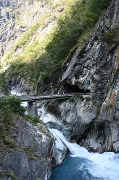 Vertical shot of the Ice blue river and the bridge over it in Tianxiang, Hualien, Taiwan