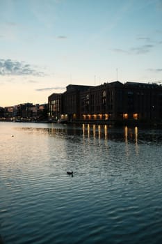 Vertical shot of an old brick building illuminated at sunset in the harbor of Munster, Germany
