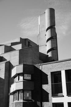 Vertical grayscale shot of a church tower with a spiral staircase