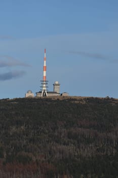 Radio tower and buildings on the Brocken mountain top under the blue sky in the Harz mountains