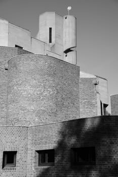 Vertical grayscale shot of a church tower with a spiral staircase