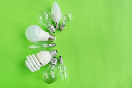 A set of different types of LED lamps isolated on a green background. Energy-saving lamps