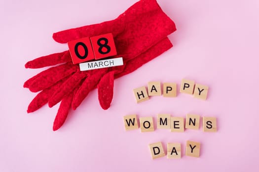 Beautiful red lace gloves on which wooden cubes with the inscription March 8, the inscription of happy women's day. Ready card for the holiday, Women's Day