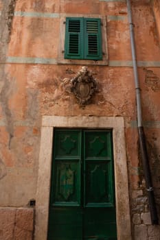 Kotor, July 5, 2021: Beautiful streets of the Old Town of Kotor, green old doors, Montenegro