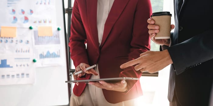 Business People Meeting using laptop computer,calculator,notebook,stock market chart paper for analysis Plans to improve quality next month. Conference Discussion Corporate Concept....