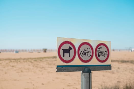Prohibiting signs prohibited dog,bicycle and loud music sign on access beach sea coast.