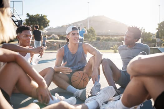 Basketball, team and friends in social conversation for sports, exercise or training in the outdoors. Athletic men in sport meeting, collaboration or communication and relaxing together on the court.