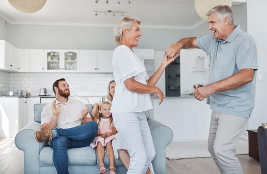 Senior couple dance together for retirement, family or marriage celebration with happiness with kid in background. Elderly pension people dancing to music with love, care and wellness in living room.