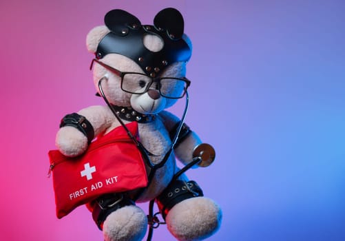 a toy teddy bear with leather straps and a mask for BDSM games with a first aid kit , safety and precautions in bdsm sex games